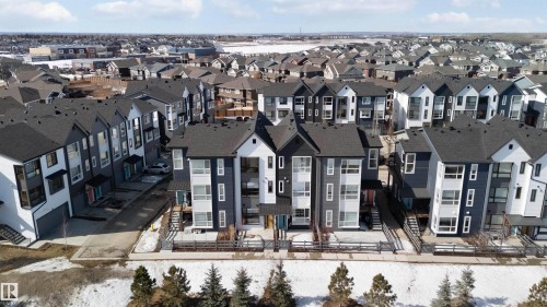 The property features a modern exterior design with dark grey and white siding, complemented by dark roofs - 49 100 Jensen Lakes Boulevard, St. Albert, AB - Outdoor With Facade