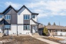 The property features a contemporary exterior with contrasting white and dark siding, a peaked roofline, and multiple windows - 10964 157 Street, Edmonton, AB  - Outdoor 