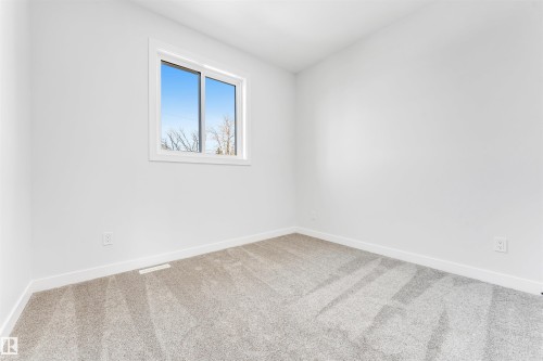 This room features light-colored walls, a window providing natural light, and light grey carpeting - 10964 157 Street, Edmonton, AB - Indoor Photo Showing Other Room