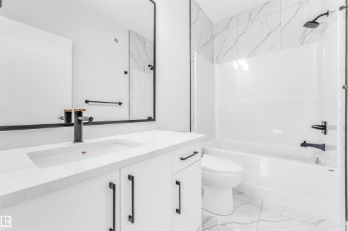 Bathroom featuring a modern vanity with a rectangular sink, a large mirror, and a sleek black faucet - 10964 157 Street, Edmonton, AB - Indoor Photo Showing Bathroom
