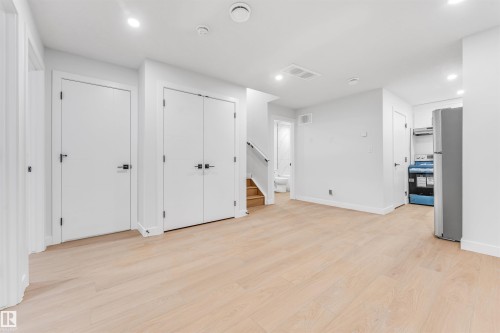 Open concept living area featuring light wood flooring, white walls, and recessed lighting - 10964 157 Street, Edmonton, AB - Indoor Photo Showing Other Room