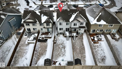 The property features a two-story exterior, a deck with railings, and a snow-covered yard with a shed - 3109 Carpenter Landing, Edmonton, AB - 