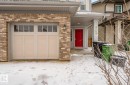 The property features a brick exterior, a garage with windows, and a prominent red front door - 3109 Carpenter Landing, Edmonton, AB  - Outdoor 