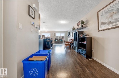 The interior features light-colored walls and dark wood-style flooring throughout - 3109 Carpenter Landing, Edmonton, AB - Indoor Photo Showing Other Room