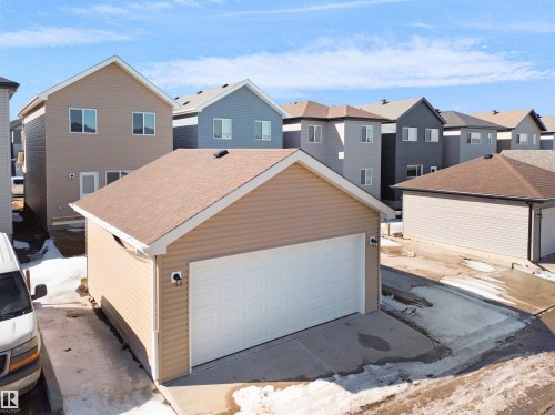The property features a detached garage with an automatic door and a paved driveway - 1304 14 Avenue, Edmonton, AB - Outdoor With Exterior