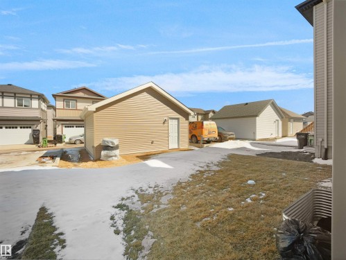 The property features a detached garage with light-colored siding and a side entry door - 1304 14 Avenue, Edmonton, AB - Outdoor