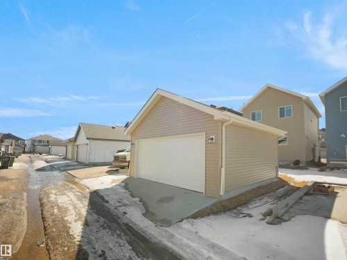 The property includes a detached garage with light-colored siding and a white garage door - 1304 14 Avenue, Edmonton, AB - Outdoor With Exterior