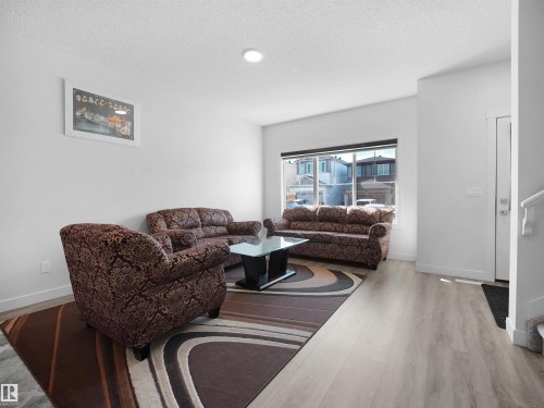Living room featuring light-colored flooring, a large window, and recessed lighting - 1304 14 Avenue, Edmonton, AB - Indoor Photo Showing Living Room