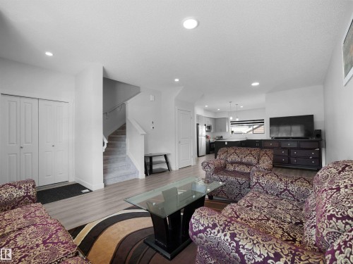 The property features an open-concept living area with light-toned flooring, recessed lighting, and a view of the kitchen - 1304 14 Avenue, Edmonton, AB - Indoor