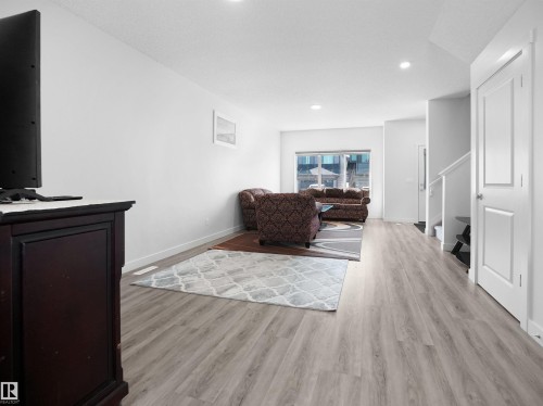 Living area featuring light-toned flooring, white walls, and a window providing natural light - 1304 14 Avenue, Edmonton, AB - Indoor