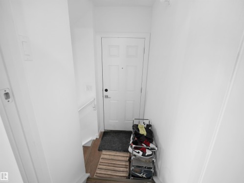 Entryway with a solid white door and light wood flooring - 1304 14 Avenue, Edmonton, AB - Indoor Photo Showing Other Room