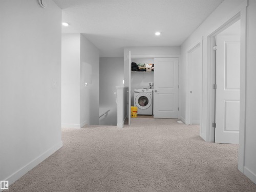 The property features a laundry area with a washer and dryer, recessed lighting, and carpeted flooring - 1304 14 Avenue, Edmonton, AB - Indoor Photo Showing Laundry Room