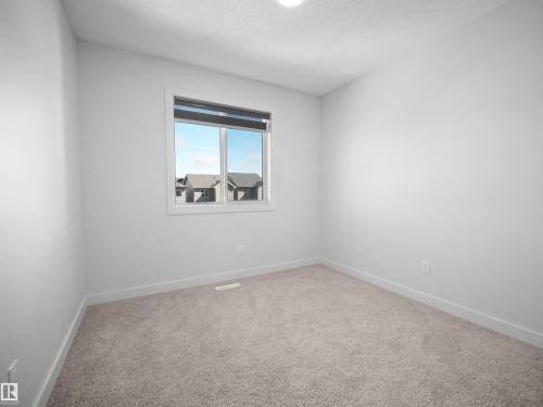 This room features soft carpeting and a window providing natural light - 1304 14 Avenue, Edmonton, AB - Indoor Photo Showing Other Room