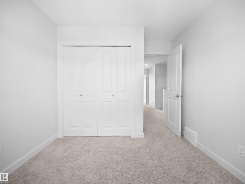 This room features light-colored walls and a carpeted floor - 1304 14 Avenue, Edmonton, AB - Indoor Photo Showing Other Room