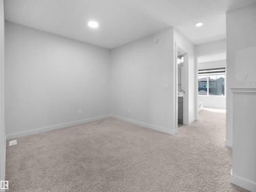 This room features light-colored carpet flooring and white walls, with recessed lighting in the ceiling - 1304 14 Avenue, Edmonton, AB - Indoor Photo Showing Other Room