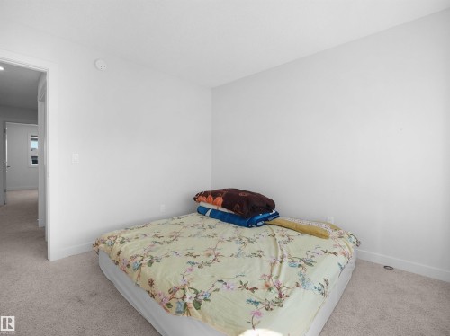 This room features light-colored carpeting and white walls, creating a neutral canvas - 1304 14 Avenue, Edmonton, AB - Indoor Photo Showing Bedroom