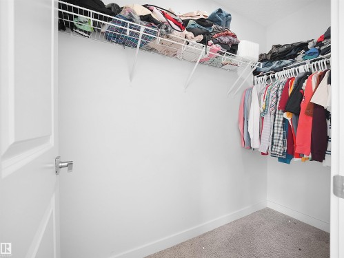 Walk-in closet featuring white wire shelving, a hanging rod, and carpet flooring - 1304 14 Avenue, Edmonton, AB - Indoor With Storage