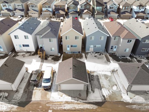 Residential property featuring a detached garage with a driveway - 1304 14 Avenue, Edmonton, AB - Outdoor