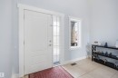 Entryway featuring a white paneled door with a sidelight, a vertical window, and light-toned tiled flooring - 6014 60 Street, Beaumont, AB  - Indoor Photo Showing Other Room 