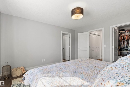 This room features light-colored walls, a ceiling-mounted light fixture, and white interior doors - 38 Hewitt Circle, Spruce Grove, AB - Indoor Photo Showing Bedroom