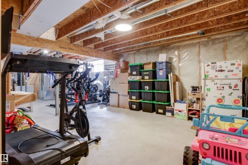 The property includes an unfinished basement with exposed wooden joists and a concrete floor - 38 Hewitt Circle, Spruce Grove, AB - Indoor Photo Showing Basement