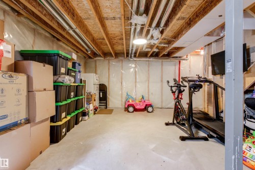 The property features a spacious, unfinished basement with exposed wooden joists and concrete flooring - 38 Hewitt Circle, Spruce Grove, AB - Indoor Photo Showing Basement