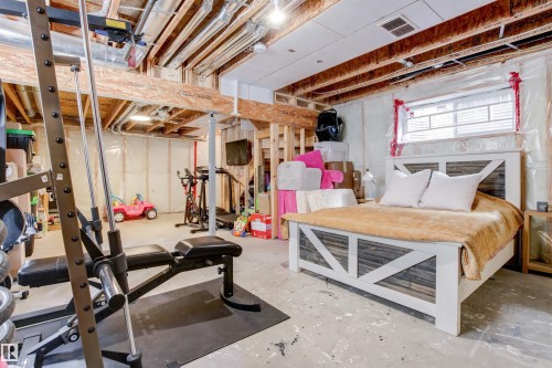 The unfinished basement offers visible wooden beams and a window - 38 Hewitt Circle, Spruce Grove, AB - Indoor Photo Showing Basement