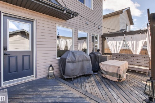 The property features an outdoor wooden deck, providing an inviting space for relaxation - 38 Hewitt Circle, Spruce Grove, AB - Outdoor With Deck Patio Veranda With Exterior