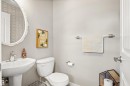 The bathroom features a pedestal sink with a modern faucet, a toilet, and light gray walls - 38 Hewitt Circle, Spruce Grove, AB  - Indoor Photo Showing Bathroom 