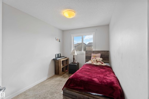This room features light-colored walls and soft carpet flooring - 2725 Orchards Road, Edmonton, AB - Indoor Photo Showing Bedroom