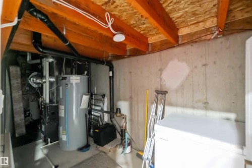 Utility area with exposed ceiling joists and concrete walls - 2725 Orchards Road, Edmonton, AB - Indoor Photo Showing Basement