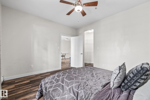 The room features hard surface flooring, a ceiling fan with integrated lighting, and a closet with shelving - 212 10611 117 Street, Edmonton, AB - Indoor
