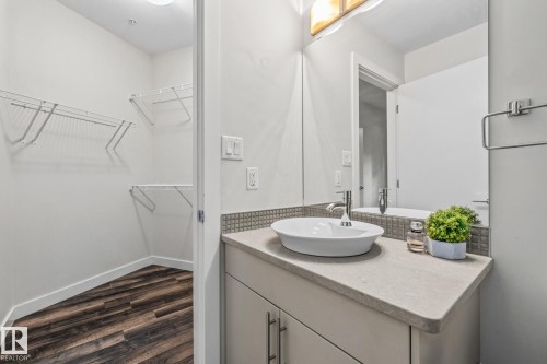 Bathroom featuring a modern vessel sink, a light-colored countertop, and a vanity with cabinet storage - 212 10611 117 Street, Edmonton, AB - Indoor Photo Showing Bathroom