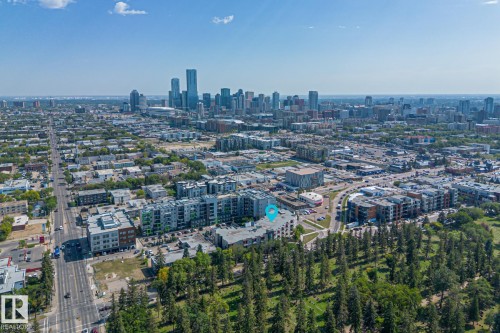Aerial view showcasing the property's location within a developed urban area, featuring city buildings and roadways - 212 10611 117 Street, Edmonton, AB - Outdoor With View