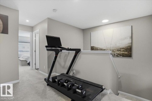 The property features light gray walls, recessed lighting, and light gray carpet - 204 Charlesworth Drive, Edmonton, AB - Indoor Photo Showing Gym Room