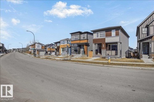 The property features a contemporary exterior with a two-story design and a covered front porch - 204 Charlesworth Drive, Edmonton, AB - Outdoor