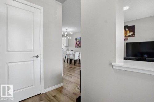 The property features light-colored walls and hardwood flooring - 204 Charlesworth Drive, Edmonton, AB - Indoor Photo Showing Other Room