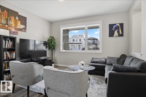 Living area with light-colored walls and dark wood-style flooring - 204 Charlesworth Drive, Edmonton, AB - Indoor Photo Showing Living Room