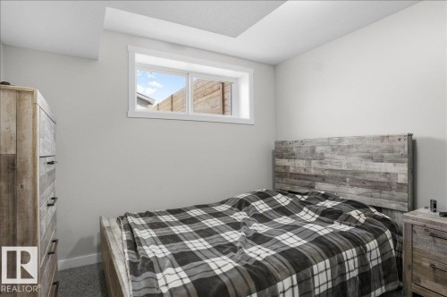 This room features light grey walls and carpeted flooring - 204 Charlesworth Drive, Edmonton, AB - Indoor Photo Showing Bedroom