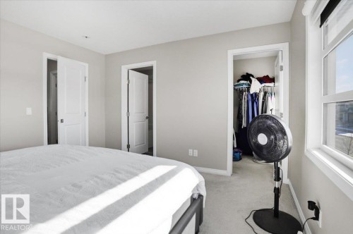 This room features light-colored walls and carpeted flooring - 204 Charlesworth Drive, Edmonton, AB - Indoor Photo Showing Bedroom