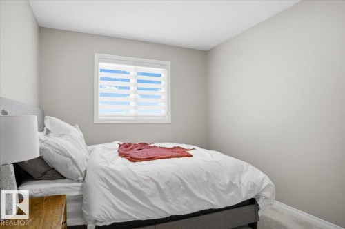 Bedroom featuring neutral tone walls, a window with horizontal blinds, and carpeting - 204 Charlesworth Drive, Edmonton, AB - Indoor Photo Showing Bedroom
