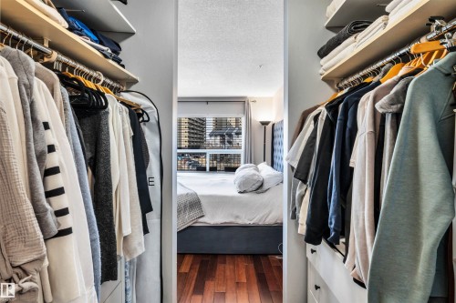 Walk-in closet featuring extensive hanging space, built-in shelving, and drawers - 319 17404 64 Avenue, Edmonton, AB - Indoor With Storage