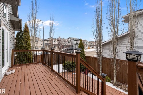 The property features a wood deck with dark railings, providing an outdoor living space - 16748 118 Street, Edmonton, AB - Outdoor With Deck Patio Veranda With Exterior