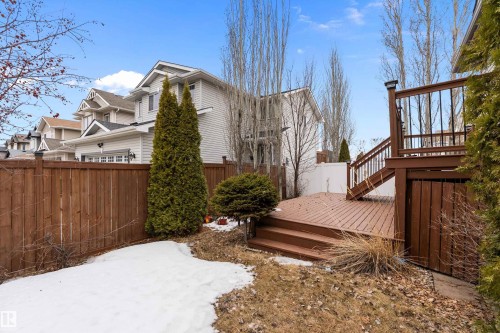 The property features a multi-level wooden deck with railings, providing an outdoor living space - 16748 118 Street, Edmonton, AB - Outdoor