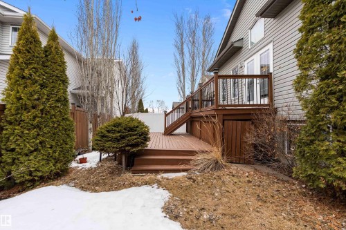 The property features a multi-level wooden deck with railings, providing outdoor living space - 16748 118 Street, Edmonton, AB - Outdoor