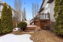 The property features a multi-level wooden deck with railings, providing outdoor living space - 