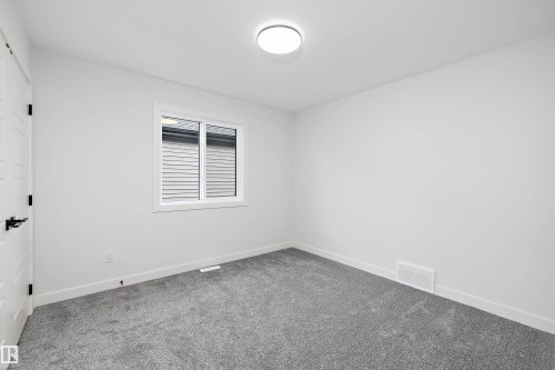 This room features grey carpet flooring and white walls, offering a neutral palette - 34 Cannes Cove, St. Albert, AB - Indoor Photo Showing Other Room