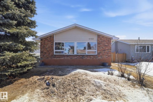 The property features a brick and siding exterior, with a prominent front window - 4129 134A Avenue Nw, Edmonton, AB - Outdoor