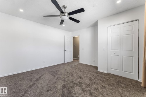 This room features neutral-toned carpeting, a ceiling fan, and recessed lighting - 2626 49 Street, Edmonton, AB - Indoor Photo Showing Other Room
