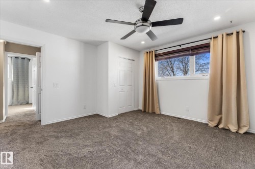 The room features carpeting, white walls, and a window providing natural light - 2626 49 Street, Edmonton, AB - Indoor Photo Showing Other Room